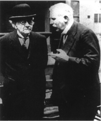 Thomson and Rutherford, c. 1930, standing having a conversation.